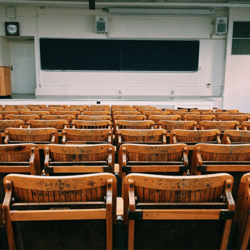 Empty wooden chairs in classroom. Explore “Can leadership skills be learned?” with Lorri Sulpizio.