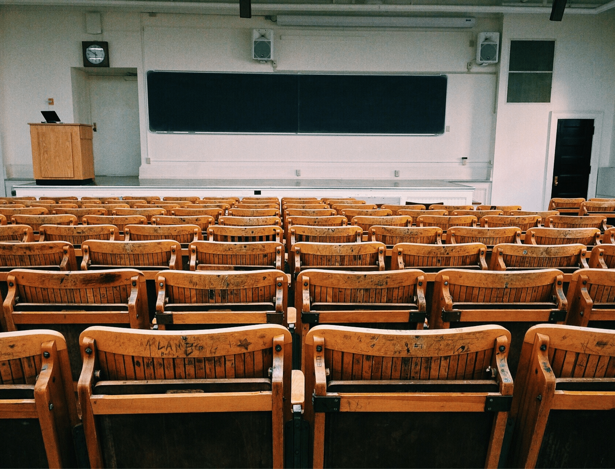 Empty wooden chairs in classroom. Explore “Can leadership skills be learned?” with Lorri Sulpizio.